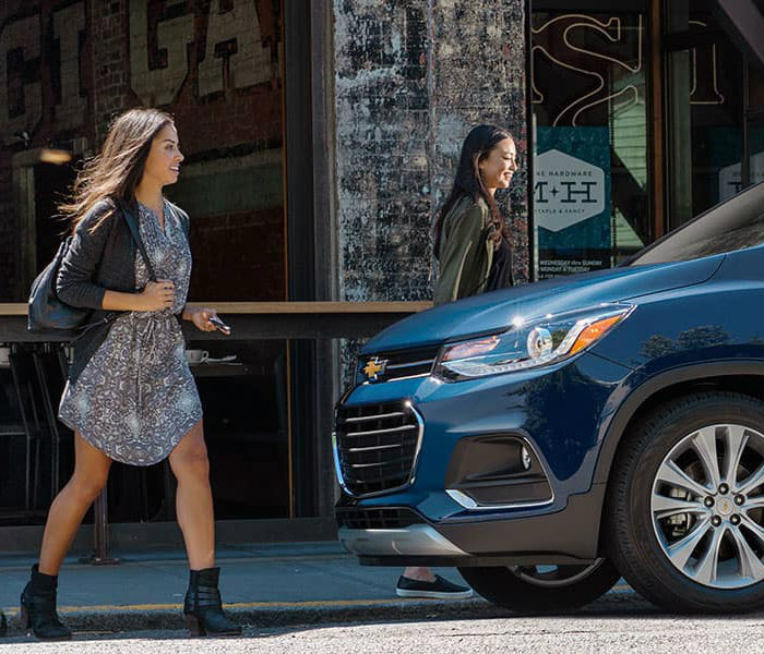 Girls walking to a Chevy SUV